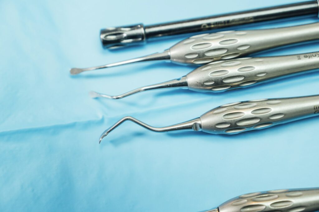 Detail of hand holding dental tools in dental clinic. Dental clinic.